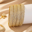 Set of 6 gold-tone wave bangles with marquise blue zircon stones – copper/brass fashion jewelry