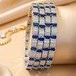 Wide silver-tone openwork bangles with colored marquise zircon stones – copper/brass fashion jewelry