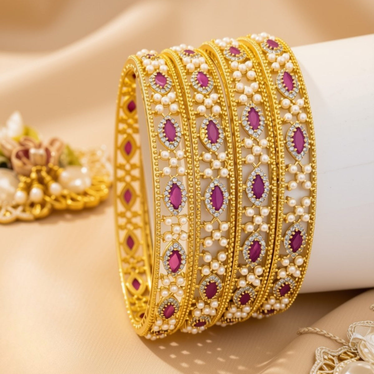 Set of 4 slim gold-tone bangles with ruby and pearl grid pavé pattern – copper/brass fashion jewelry