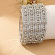 Set of 4 silver-tone bangles with emerald green flower clusters on clear pavé zircon background – copper/brass fashion jewelry